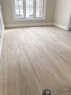 an empty room with hard wood flooring and white trim on the windowsills