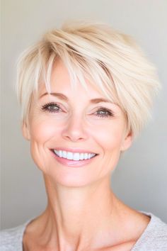 Side-Swept Pixie Hairstyle on a smiling woman in her 50s with short platinum blonde hair.