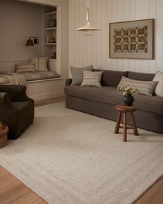 a living room with two couches, a chair and a coffee table in it