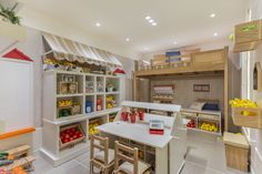 a kitchen with lots of wooden furniture and shelves filled with fruits, vegetables, and other items