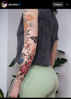 a woman's arm with flowers and birds on it