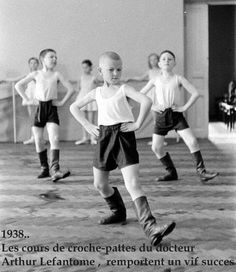 a group of young boys standing next to each other on top of a hard wood floor