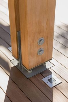 a wooden box sitting on top of a wooden floor next to a metal square object