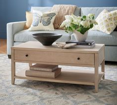 a coffee table with flowers and books on it