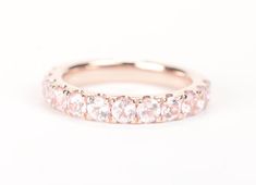 an image of a wedding band with pink stones