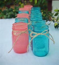 mason jars lined up on a table with twine rope around the top and bottom