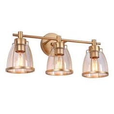 three light brass bathroom fixture with clear glass shades