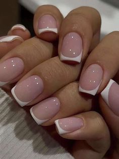 a woman's hands with pink and white french manies