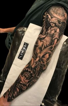 a man's arm with an angel tattoo on it