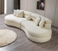 a large white couch sitting on top of a hard wood floor