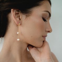 Two earrings in one—our Remi Pear Drop Earrings are our most delicate and versatile bridal earrings yet. Wear the Remis with the pearl earring back for your bridal shower or next GNO. Then, on your big day, wear the Remis with a standard earring back for a fresh and classic look. Gold plate over brass Freshwater pearls Cubic zirconia accents Nickel- and lead-free Dangling Pearl Earrings Wedding, Delicate Pearl Earrings For Evening, Feminine Gold Pearl Earrings For Wedding, Pearl White Linear Earrings With Pearl Charm For Wedding, Graceful Dangle Pearl Earrings For Wedding, Long Drop Pearl Charm Earrings For Wedding, Delicate Dangle Pearl Earrings For Evening, Dainty Pearl Drop Chandelier Earrings For Wedding, Wedding Linear Earrings With Pearl Charm In Pearl White