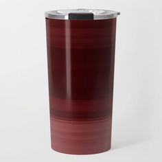 a red and black cup sitting on top of a white table