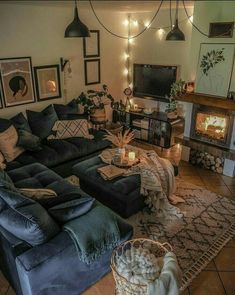 a living room filled with furniture and a fire place next to a wall mounted tv