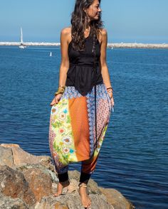 "Beautiful Handmade pair of harem pants for both men and women. Wonderful yoga or lounge wear outfit. Ethically made using soft Upcycled material. -Unisex - Stretch - Flowing relaxed fit - 2 side pockets + inner drawstring to secure the waist. Great for Yoga, Dance, Exercises, Meditations, Yoga Practice and beyond... Materials: black color cotton jersey combined with an upcycled colorfully printed light jersey fabric. Fabrics for this pair were bought in Fashion Districts in NY and LA and the pa Bohemian Harem Pants With Elastic Waistband For Loungewear, Baggy Harem Yoga Pants For Spring, Harem Yoga Pants With Elastic Waistband For Loungewear, Bohemian Harem Pants For Summer Loungewear, Beach Baggy Harem Pants With Elastic Waistband, Bohemian Harem Bottoms With Relaxed Fit, Baggy Harem Pants With Elastic Waistband For Beach, Summer Harem Pants For Loungewear, Summer Harem Parachute Pants With Elastic Waistband