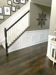 the stairs in this house have been painted white and are decorated with pictures on the wall