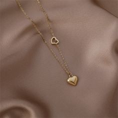 Make everyone fall head over heels for your look with this 18k gold-plated necklace decorated with two heart pendants. Chain : 15.75" L with 2.56" extender Pendant : 0.39" L Lobster claw clasp 18k gold-plated copper Heart Pendants, Head Over Heels, Two Hearts, Gold Plated Necklace, Heart Pendant Necklace, Lobster Claw, Heart Pendant, Gold Jewelry, Choker Necklace