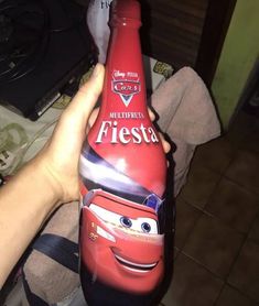 someone is holding up a bottle with the character from cars on it in their hand