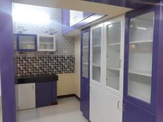 a kitchen with purple and white cabinets in it