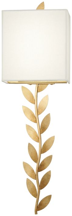 a table lamp with a white shade on it and a gold leaf design around the base