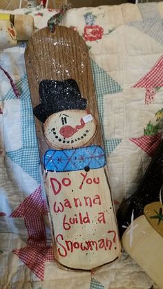 a wooden snowboard with a sign that says do you wanna to build a snowman?