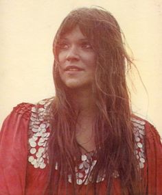 a woman with long hair wearing a red shirt