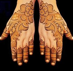 two hands with henna tattoos on them