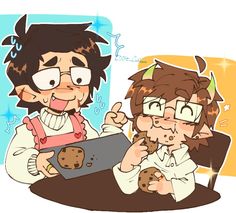 two people sitting at a table with cookies in front of them and one person holding a cookie