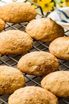 freshly baked muffins cooling on a wire rack with flowers in the back ground