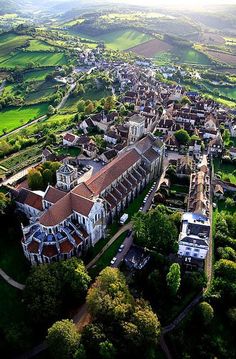 an aerial view of a town surrounded by green fields