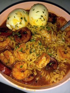 a bowl filled with noodles, shrimp and eggs