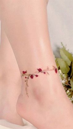 a close up of a person's foot with flowers on it