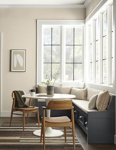 a living room filled with furniture and lots of windows