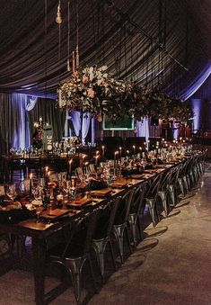 a long table is set up with candles and place settings for dinner guests to enjoy