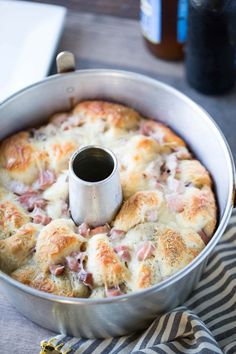 ham and cheese casserole in a metal pan with a napkin on the side