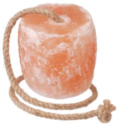 a rope wrapped around an orange piece of soap on top of a white background,