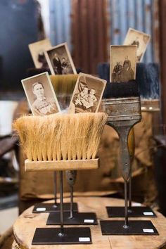 an old brush is sitting on top of a stand with pictures in the back ground