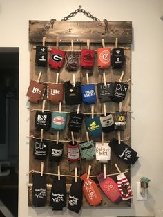 there is a wooden board with many socks hanging on the clothes pins and some other items