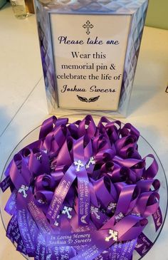 a plate with purple ribbons on it next to a sign