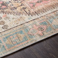 an area rug on top of a wooden floor