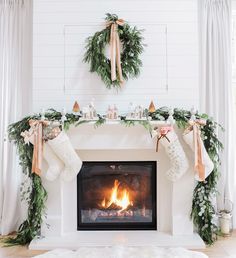 a living room with a fireplace decorated for christmas