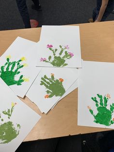 four handprints are on the table with flowers