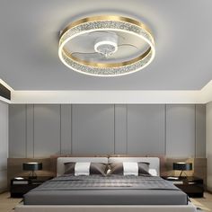 a large bed sitting under a ceiling light in a bedroom next to two nightstands