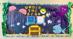 under the sea bulletin board with ocean animals and jellyfish on it's side