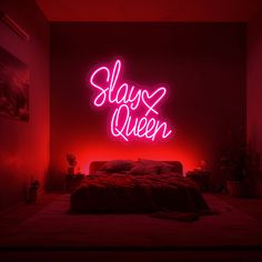 a bed in a room with a neon sign above it that says slay queen