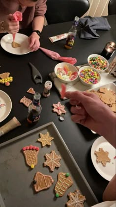 some people are making christmas cookies on the table