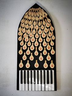 a black and white piano with wooden decorations on it