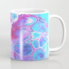 a coffee mug with blue, pink and purple swirls on it