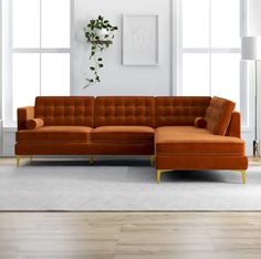 a living room with an orange couch and white rug