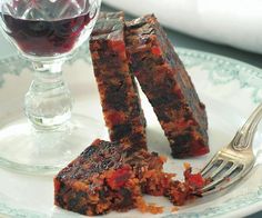 two pieces of fruit cake on a plate with a fork