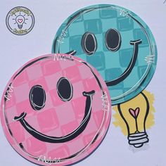 two paper plates with faces and a light bulb on the top one has a smiley face painted on it